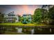 Scenic waterfront property featuring a charming two-story home with lush green lawn and mature trees at 17 Trigger Fish Ln., Murrells Inlet, SC 29576