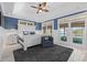 Bright main bedroom with tray ceilings, doors to balcony and a cozy chair at 17 Trigger Fish Ln., Murrells Inlet, SC 29576