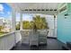 Covered porch with a white wicker furniture set and neighborhood views at 17 Trigger Fish Ln., Murrells Inlet, SC 29576