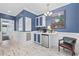 Charming wet bar features wainscoting, mini-fridge, and white cabinets with contrasting blue trim at 17 Trigger Fish Ln., Murrells Inlet, SC 29576