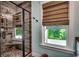Modern bathroom features a tiled shower with a glass door and a window at 1737 24Th Ave. N, North Myrtle Beach, SC 29582