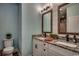 Modern bathroom featuring double sinks, granite countertops, and framed mirrors with warm lighting at 1737 24Th Ave. N, North Myrtle Beach, SC 29582