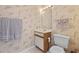Cozy half bathroom with vanity, mirror and charming wall paper at 1890 Colony Dr. # 17L, Surfside Beach, SC 29575