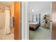 View from bathroom into bedroom features queen bed, TV stand, and bright natural lighting at 1890 Colony Dr. # 17L, Surfside Beach, SC 29575