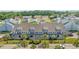 Exterior aerial view of gray two-story townhomes with well-maintained landscaping and ample parking at 1890 Colony Dr. # 17L, Surfside Beach, SC 29575