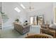Bright living room with vaulted ceiling, skylights, and access to a balcony with scenic views at 1890 Colony Dr. # 17L, Surfside Beach, SC 29575