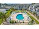 Aerial view of a community pool with lounge chairs and tables, surrounded by manicured landscaping and residential buildings at 1890 Colony Dr. # 17L, Surfside Beach, SC 29575