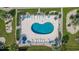 Aerial view of kidney-shaped community pool, surrounding lounge chairs, tables, landscaping, and a nearby jacuzzi at 1890 Colony Dr. # 17L, Surfside Beach, SC 29575