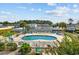 Community pool area with lounge chairs, umbrellas and grilling area at 1890 Colony Dr. # 17L, Surfside Beach, SC 29575