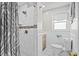 Modern bathroom featuring a walk-in shower with white tile and decorative band, plus a toilet at 2006 S Ocean Blvd., North Myrtle Beach, SC 29582