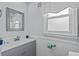 Cozy bathroom featuring a frosted window, white wainscoting, and a modern sink at 2006 S Ocean Blvd., North Myrtle Beach, SC 29582