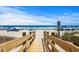 Wooden walkway leading to a beautiful beach with blue skies and ocean views at 2006 S Ocean Blvd., North Myrtle Beach, SC 29582