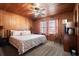 Comfortable bedroom featuring wood paneling, a ceiling fan, and a cozy atmosphere at 2006 S Ocean Blvd., North Myrtle Beach, SC 29582