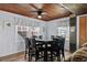 Charming dining room with wood ceiling, large windows, and seating for eight at 2006 S Ocean Blvd., North Myrtle Beach, SC 29582