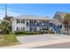 Charming two-story beach house with blue accents, inviting balconies, and well-maintained landscaping at 2006 S Ocean Blvd., North Myrtle Beach, SC 29582