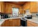Well-lit kitchen with wood cabinets, mosaic backsplash, and modern appliances at 2006 S Ocean Blvd., North Myrtle Beach, SC 29582