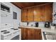 Kitchen featuring wood cabinets, white appliances, and ample counter space at 2006 S Ocean Blvd., North Myrtle Beach, SC 29582