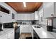 Modern kitchen featuring white cabinets, stone countertops, and updated appliances at 2006 S Ocean Blvd., North Myrtle Beach, SC 29582