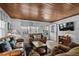 Cozy living room with wood ceiling, comfortable seating, and natural light at 2006 S Ocean Blvd., North Myrtle Beach, SC 29582