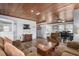 Comfortable living room with wood paneling, cozy seating, and dining area at 2006 S Ocean Blvd., North Myrtle Beach, SC 29582