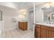 Bright bathroom featuring tile floors, double sinks with wood cabinets, and an open doorway to another vanity at 2180 Waterview Dr. # 1036, North Myrtle Beach, SC 29582
