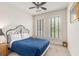 Bedroom with large bed, a ceiling fan and two windows that provide plenty of natural light at 2180 Waterview Dr. # 1036, North Myrtle Beach, SC 29582