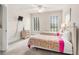 Bright bedroom featuring two twin beds, ceiling fan, and large windows at 2180 Waterview Dr. # 1036, North Myrtle Beach, SC 29582