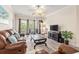 Bright living room with wood floors, balcony doors, and comfortable leather furniture at 2180 Waterview Dr. # 1036, North Myrtle Beach, SC 29582