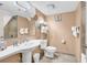 Well-lit bathroom featuring a pedestal sink, toilet, large mirror, and walk-in shower at 2301 S Ocean Blvd. # 1405, North Myrtle Beach, SC 29582