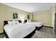 Bright bedroom with two queen beds, soft lighting, neutral decor, and decorative artwork at 2301 S Ocean Blvd. # 1405, North Myrtle Beach, SC 29582