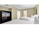 Comfortable bedroom with two beds, a TV, closet, and a door leading to an attached bathroom at 2301 S Ocean Blvd. # 1405, North Myrtle Beach, SC 29582