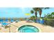 Relaxing hot tub overlooking the ocean and a furnished patio area with palm trees at 2301 S Ocean Blvd. # 1405, North Myrtle Beach, SC 29582