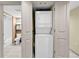 Efficient condo with stacked washer and dryer concealed behind white doors and a view into the bathroom at 2301 S Ocean Blvd. # 1405, North Myrtle Beach, SC 29582