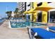 Outdoor swimming pool surrounded by lounge chairs and yellow umbrellas on a sunny day at 2301 S Ocean Blvd. # 1405, North Myrtle Beach, SC 29582