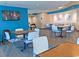 Bright dining area with tables and chairs, TV, and ocean views at 2301 S Ocean Blvd. # 702, North Myrtle Beach, SC 29582