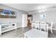 Bright condo interior featuring an open floor plan with a dining area, TV and views into the kitchen area at 2301 S Ocean Blvd. # 702, North Myrtle Beach, SC 29582