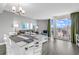 Bright living area with a dining table, comfortable seating, and balcony access that offers views of the cityscape at 2301 S Ocean Blvd. # 702, North Myrtle Beach, SC 29582