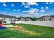 Spacious backyard with a white fence, lush green grass, trampoline and a playground at 2461 Summerhaven Loop, Conway, SC 29527