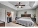 Bright main bedroom featuring tray ceiling, ceiling fan, and neutral color scheme at 2461 Summerhaven Loop, Conway, SC 29527