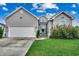Charming home featuring gray siding, well-maintained lawn, and an attached two-car garage at 2461 Summerhaven Loop, Conway, SC 29527