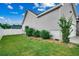 Exterior view of the side yard showing manicured landscaping, a privacy fence, and well-kept grass at 2461 Summerhaven Loop, Conway, SC 29527