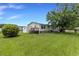Spacious backyard with lush grass, a deck, and a shed; ideal for outdoor activities and storage at 259 Iroquis Trail, Longs, SC 29568