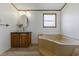 Well-lit bathroom featuring a garden tub, vanity, and updated fixtures at 259 Iroquis Trail, Longs, SC 29568
