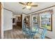 Charming dining area with a glass table, four chairs, and a view into the adjacent kitchen at 259 Iroquis Trail, Longs, SC 29568