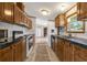 Galley style kitchen with wood cabinets, stainless steel appliances and durable countertops at 259 Iroquis Trail, Longs, SC 29568