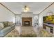 Cozy living room features stone fireplace, wood-look floors, and lots of natural light at 259 Iroquis Trail, Longs, SC 29568