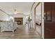 Open living room with a stone fireplace and views into the bedroom, creating a cozy atmosphere at 259 Iroquis Trail, Longs, SC 29568