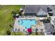 Aerial view of the pool with lounge chairs and umbrellas, surrounded by lush green grass at 259 Iroquis Trail, Longs, SC 29568