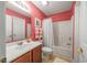 Bathroom with a single sink vanity, tub with shower, and flamingo-themed decor at 265 Connemara Dr. # D, Myrtle Beach, SC 29579