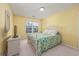 Bedroom featuring yellow walls, a comfortable bed, and a sunny window at 265 Connemara Dr. # D, Myrtle Beach, SC 29579
